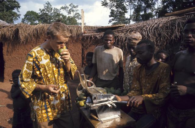 UNT Peace Corps volunteer wearing traditional local clothing and eating local food