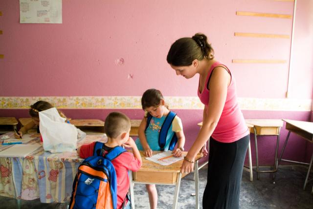 UNT Peace Corps volunteer working in a community school with children